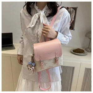 Detail of color-block mini backpack featuring butterfly prints and pink lychee texture flap