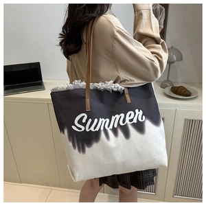 Detail of canvas beach tote showing fringe edges and Summer script on gradient fabric