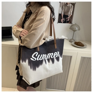 Detail of canvas tote bag showing fringe edges and Summer print on gradient fabric