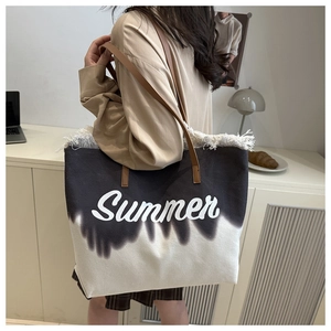 Close-up of canvas tote bag featuring Summer print, white fringe detail and brown strap