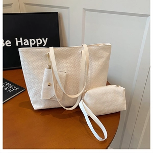 Detailed view of beige woven tote bag set with three-piece textured PU leather storage pouches