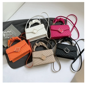 Detailed view of gathered cloud handles and V-shaped quilted PU leather crossbody bags