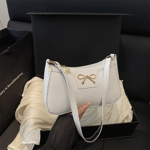 Elegant white bow shoulder bag in pebble grain PU leather with gold butterfly buckle