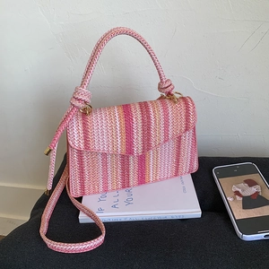 Pink striped hand-woven crossbody bag with a flip cover and elegant golden hardware