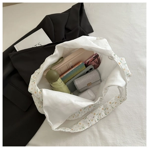 Sac fourre-tout à fleurs spacieux contenant un parapluie, des livres et un portefeuille