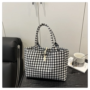 Dettaglio della borsa tote in tela vichy con cinturino in corda e fibbia in corno
