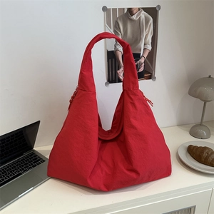 Large capacity bright red nylon tote bag for women featuring drawstring details