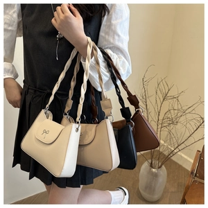 Detailed display of four retro crossbody bags featuring woven handles and bow buckles