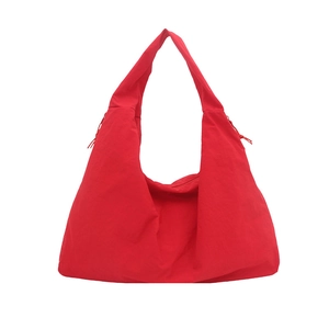 Large red nylon tote bag for women with a minimalist hobo shape and soft shoulder strap