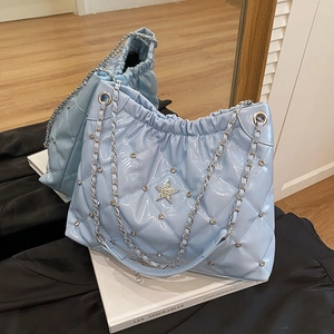 Light blue quilted chain bucket bag with rhinestone star charms and silver metal strap