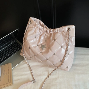 Pink quilted patent leather bucket bag with star logo and silver chain strap