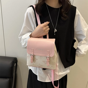 Pink and beige two-tone mini backpack with butterfly patterns and leather top flap