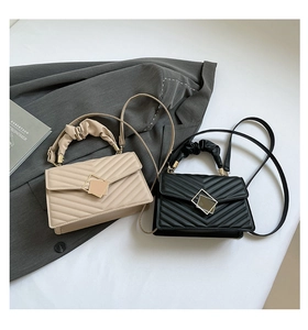 Detail of diamond quilted crossbody bags with gold hardware and cloud handles