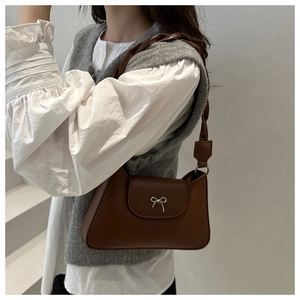 Brown retro underarm bag with silver bow accent and twisted woven shoulder strap detail