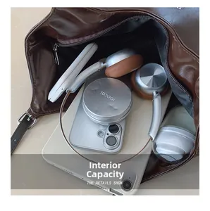 Top view of spacious interior of brown tote bag with tablet and daily essentials