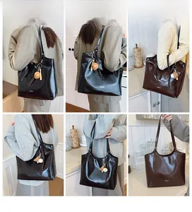 Detailed views of high-capacity tote bags in black and dark brown with charm details