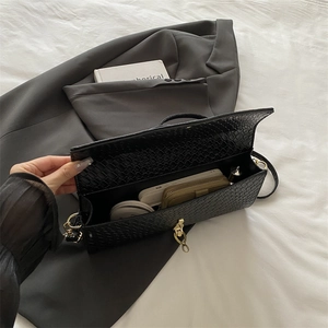 Borsa a mano nera in pelle goffrata con dettagli dorati e interno capiente