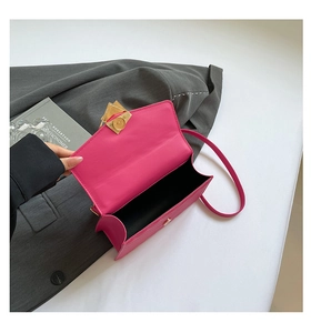 Hot pink quilted crossbody bag with golden magnetic snap closure and textured leather detail