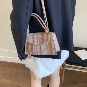 Striped woven shoulder bag in brown and beige with hollow knit design and crossbody strap