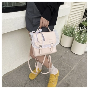 Detail of pink Lolita PU backpack featuring white lace trim and plaid ribbon bows