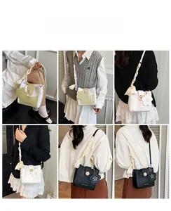 Detailed views of crossbody bags featuring decorative scarves and floral charm accents
