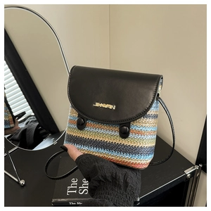 Close-up of rainbow woven straw bucket bag with black leather flap and metal logo