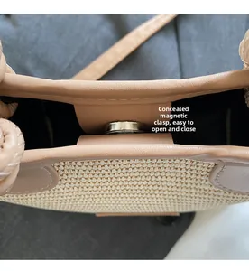 Detail of the hidden magnetic closure on the woven straw bag for easy and quick access