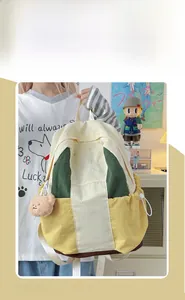 Detailed view of color-block nylon backpack with a plush bear charm in a lifestyle setting