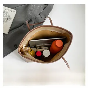 Top view of cream tote bag interior showing large capacity with daily essentials inside