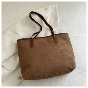 Detail of the caramel tote bag with matte texture and dark brown leather shoulder straps