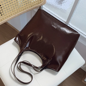 Glossy dark brown tote bag with FASHION logo and adjustable strap for commuting