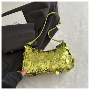 Dettaglio di paillettes verde neon su una borsa a tracolla alla moda con finitura metallica