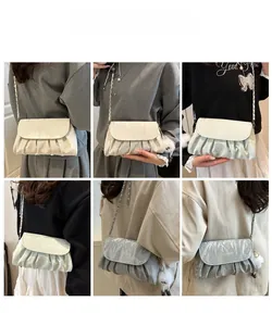 Three pleated chain crossbody bags in beige, green, and silver grey on models