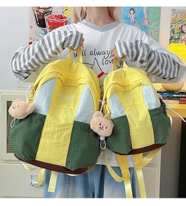 Comparison of large and small nylon color-block backpacks with cute bear charm