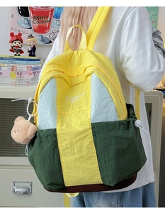 Student backpack with yellow and green color-block nylon fabric and plush bear pendant