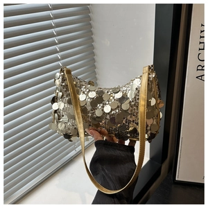 Detail van zilveren pailletten en gouden riem op een stijlvolle avondtas voor dames