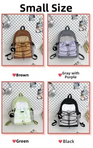 Detailed view of four small canvas backpacks in brown, purple-grey, green and black colors