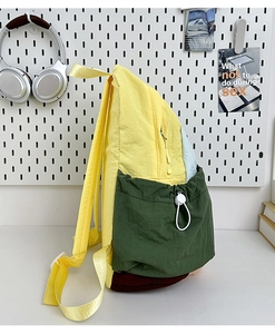 Detail of color-block nylon backpack with drawstring side pocket and side zipper