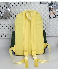 Detail of adjustable padded shoulder straps on a yellow and green contrast nylon backpack