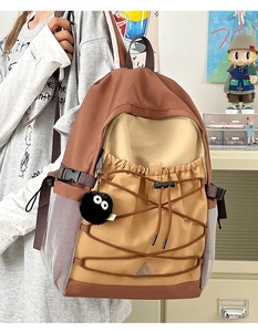 Detail view of the canvas backpack with color stitching, mesh side pocket and logo