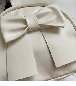 Close-up of stylish off-white bow-knot handbag made of premium matte faux leather