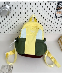 Detail of multi-color nylon backpack with DUOMAN BAG embroidery and yellow straps