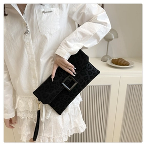 Detail of a vintage leopard print suede envelope clutch with a square buckle