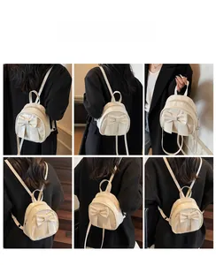 Cream white mini backpack with bow detail shown in various carrying styles on a model