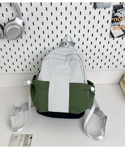 Detail view of mini contrast color nylon backpack with side drawstring and logo print
