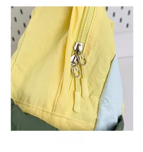 Detail of smooth double zipper with contrast pull cords on nylon backpack for students