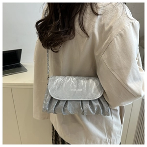 Detail of silver pleated shoulder bag with metallic chain and fashion text print