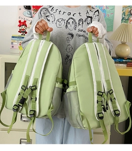 Detail view of matcha green canvas backpack showing adjustable chest buckles and mesh side pocket
