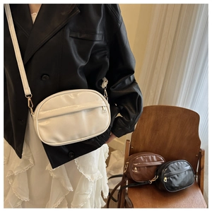 Minimalist crossbody bags displayed in white, brown and black with adjustable straps