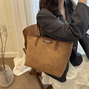 Brown suede tote bag with leather handles and large capacity for daily commuting